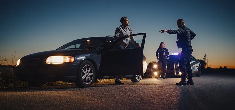 A photo of a exiting their car at a police officer's instructions.