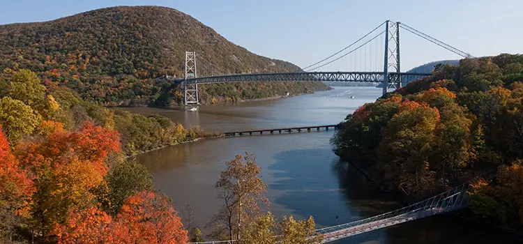 A photo of the Bear Mountain Bridge spanning the Hudson River in autumn.